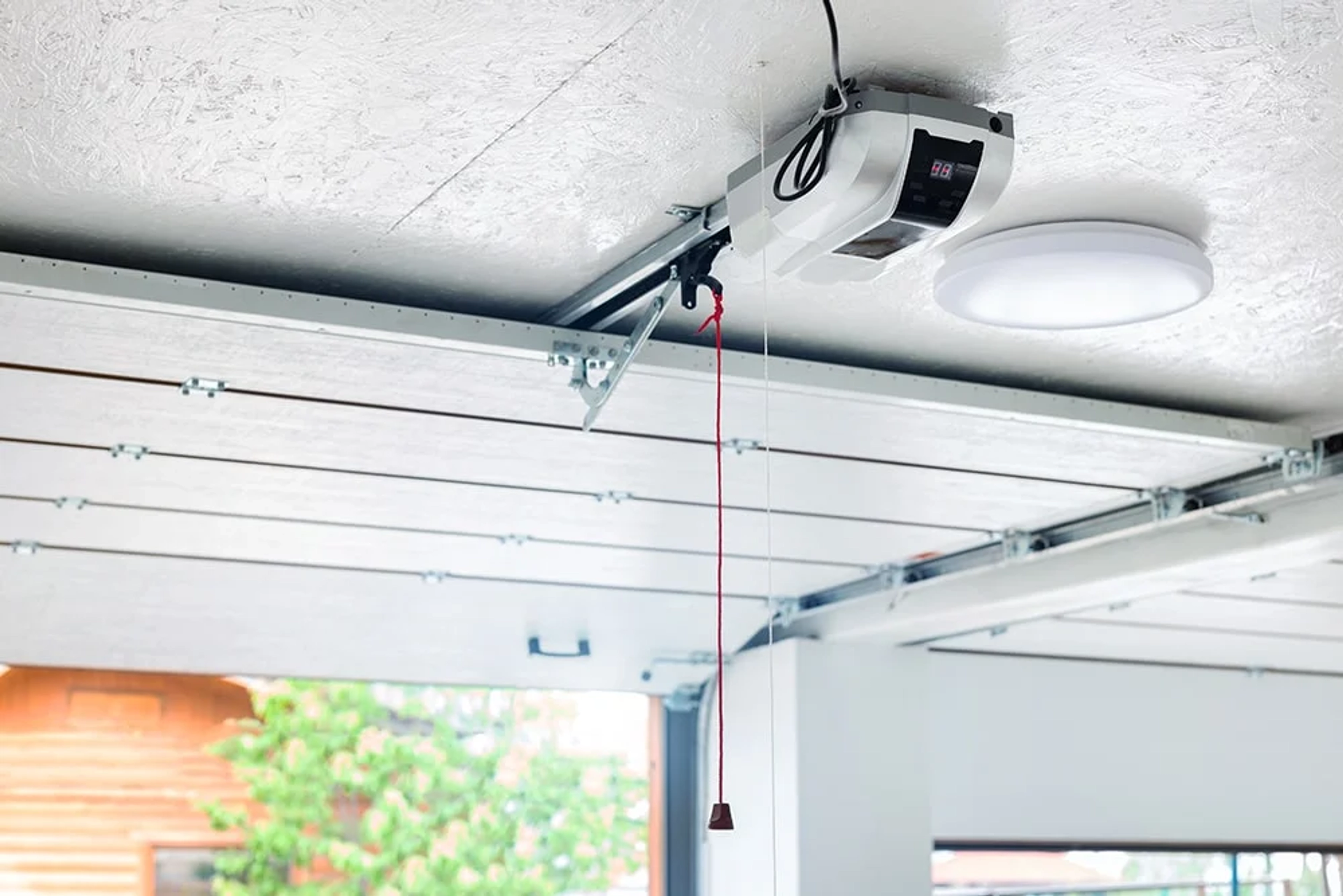 Réglage câble porte de garage sectionnelle